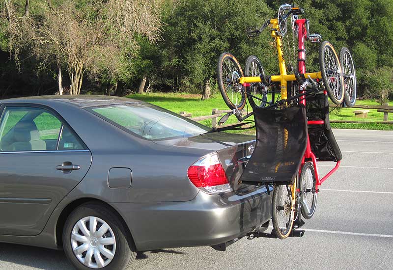 Two tadpole trikes on hangar support arm trike rack